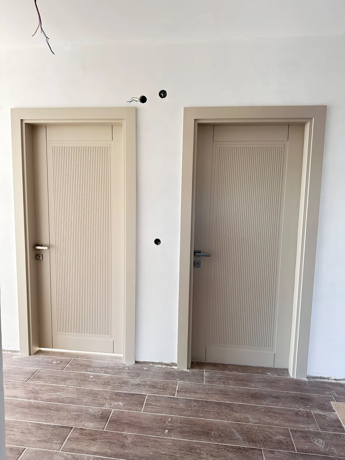 Modern beige lacquered interior door with routed grooves