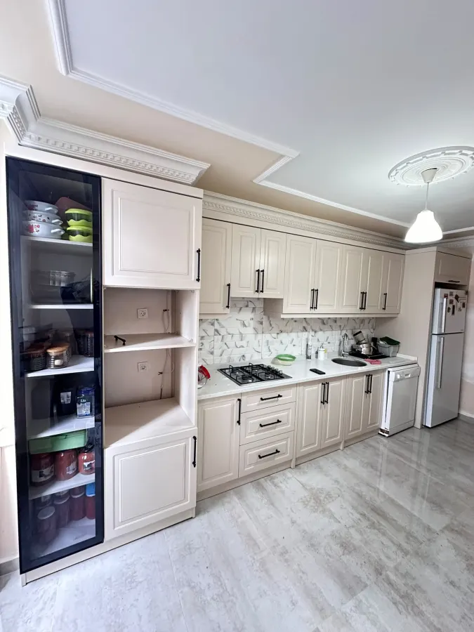 Cream classic kitchen with a glazed larder column